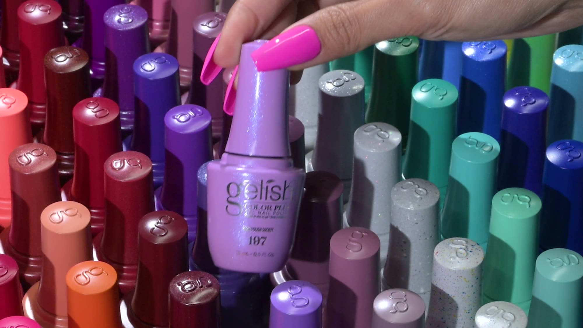 Five hands with Color Plus manicures in nude, pink, red, green and blue